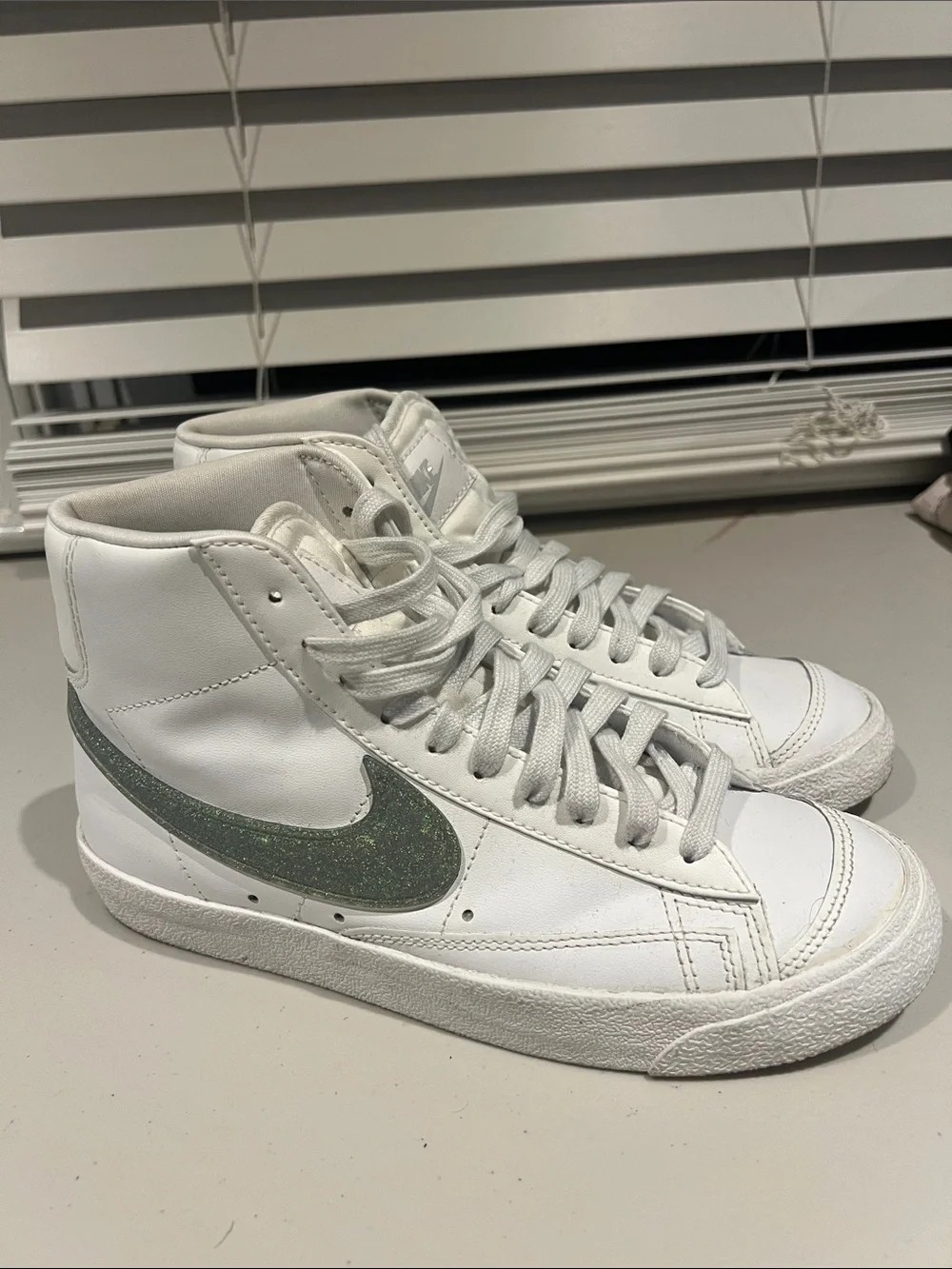 Nike White High-Top Sneakers with Green Swoosh Accent